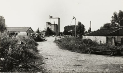 4831 Gezicht op de Havenstraat met rechts de schoorsteen van Vredestein, in het midden de silo ('Boerenbond') aan de ...