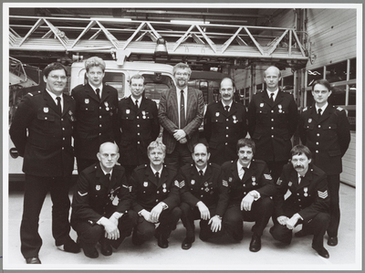 WAT001014291 Medailles Brandweer.Burgemeester Th. van Dam te midden van de onderscheiden brandweerlieden. Zittend ...