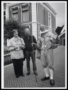 WAT003006348 Dirk van Os leidt bezoekers rond. Op de achtergrond Middelwijk (Rijksmonument)