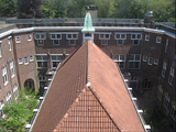 6483 van bovenaf zicht op dak kerk en diverse gebouwen Marienbosch, 09-05-2012