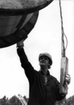 153422 Afbeelding van een wegwerker tijdens het takelen van een kabelhaspel te Amersfoort.