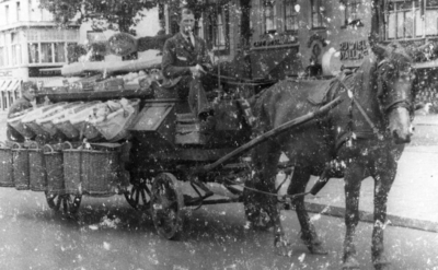 121899 Afbeelding van groenteboer Nico Bergsteijn (geb. 7 nov. 1914) op zijn groentekar met paard; links op de ...
