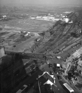 156391 Overzicht van het emplacement en de Woenselse Overweg te Eindhoven, met op de achtergrond de werkzaamheden voor ...