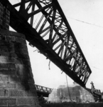 157334 Gezicht op een scheefhangend brugdeel van de tijdens de oorlog vernielde spoorbrug over de Waal bij Zaltbommel.