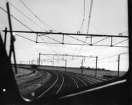 167763 Gezicht op de bocht in de spoorlijn bij Harderwijk vanuit de cabine van een rijdende trein.